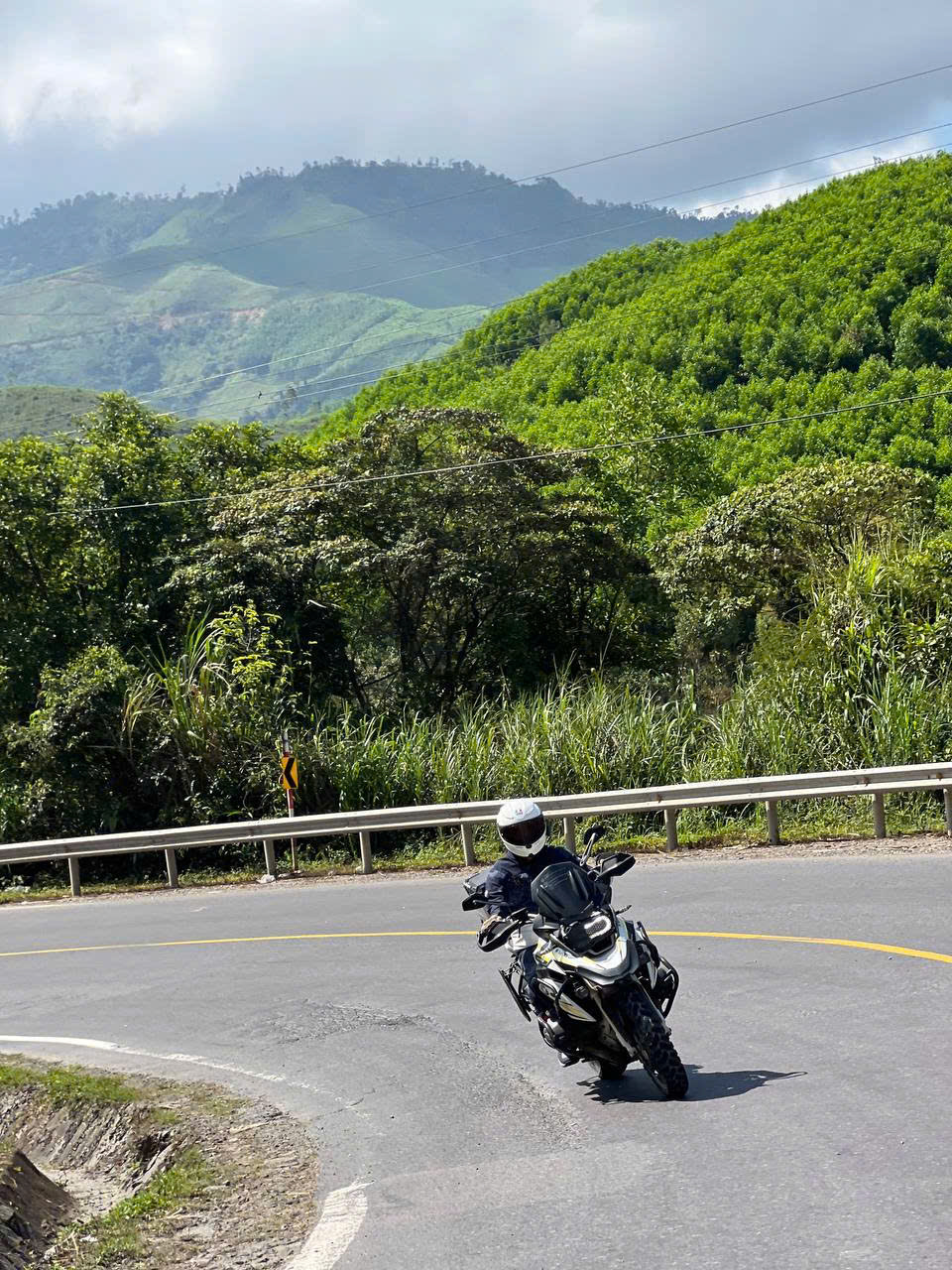 BMW GS leaning through a mountain hairpin