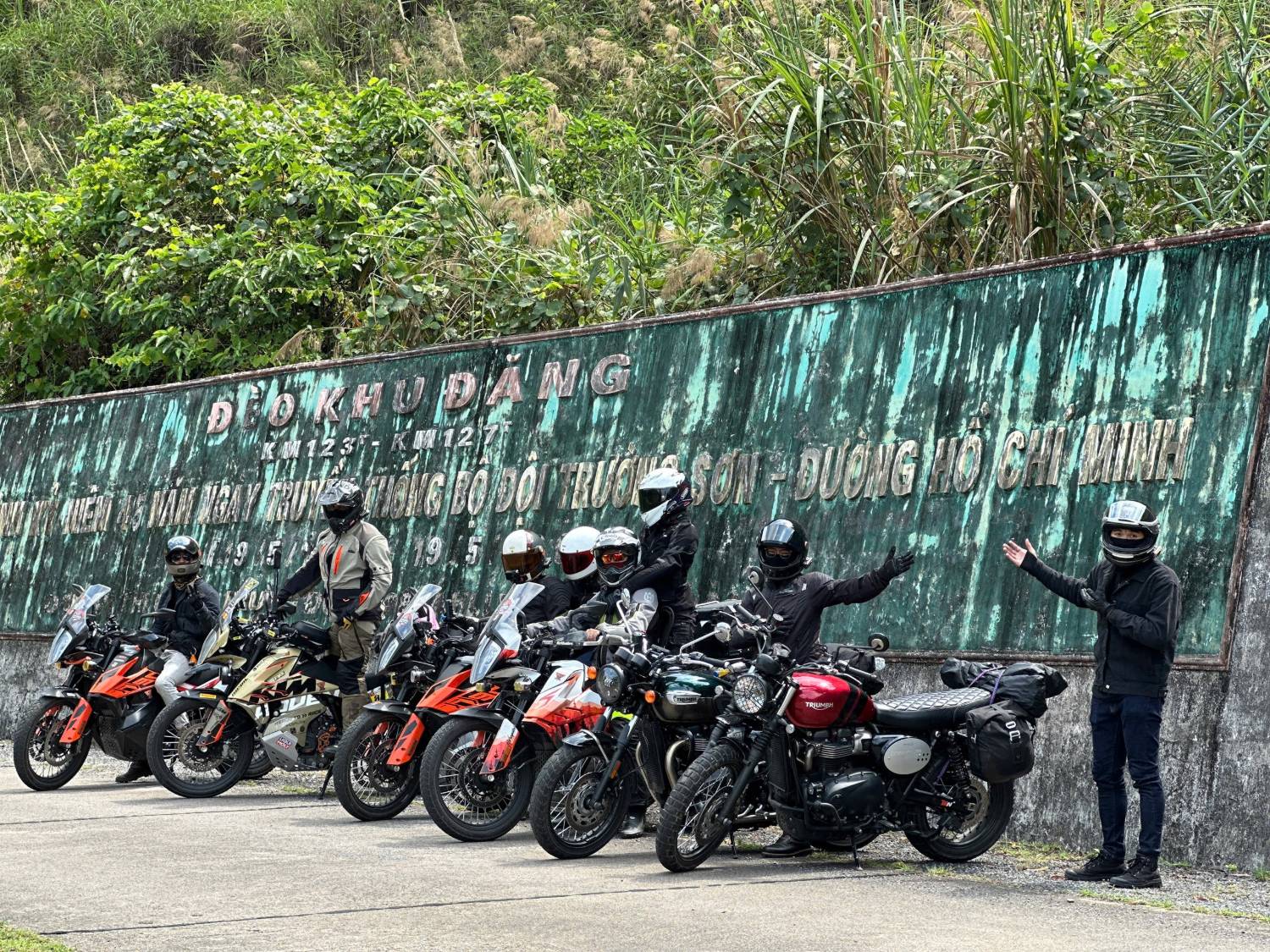 KTM and Triumph bikes lined up at the Khu Dang Pass memorial