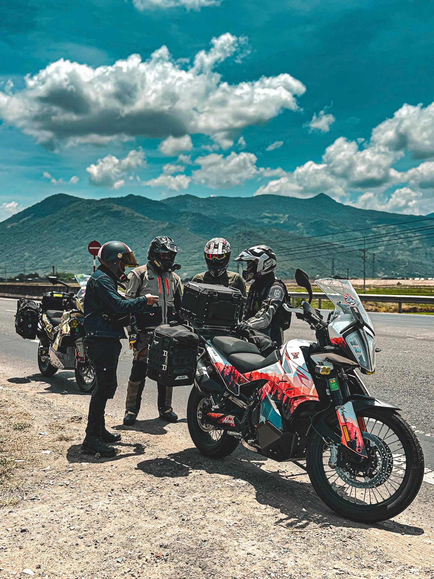 Riders checking the route beside a KTM 790 Adventure