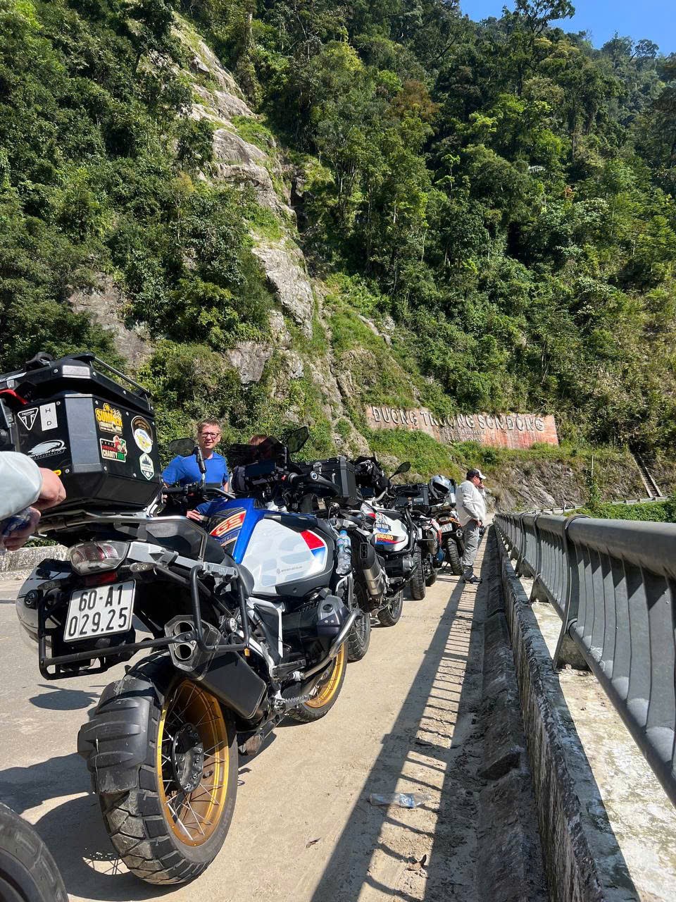 Bikes parked on a bridge below the Truong Son road sign