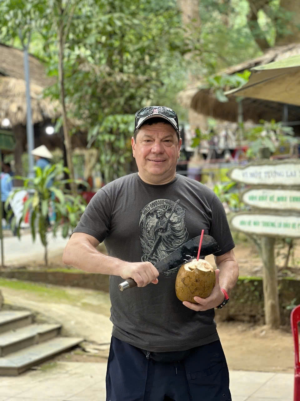 Rider opening a fresh coconut with a machete