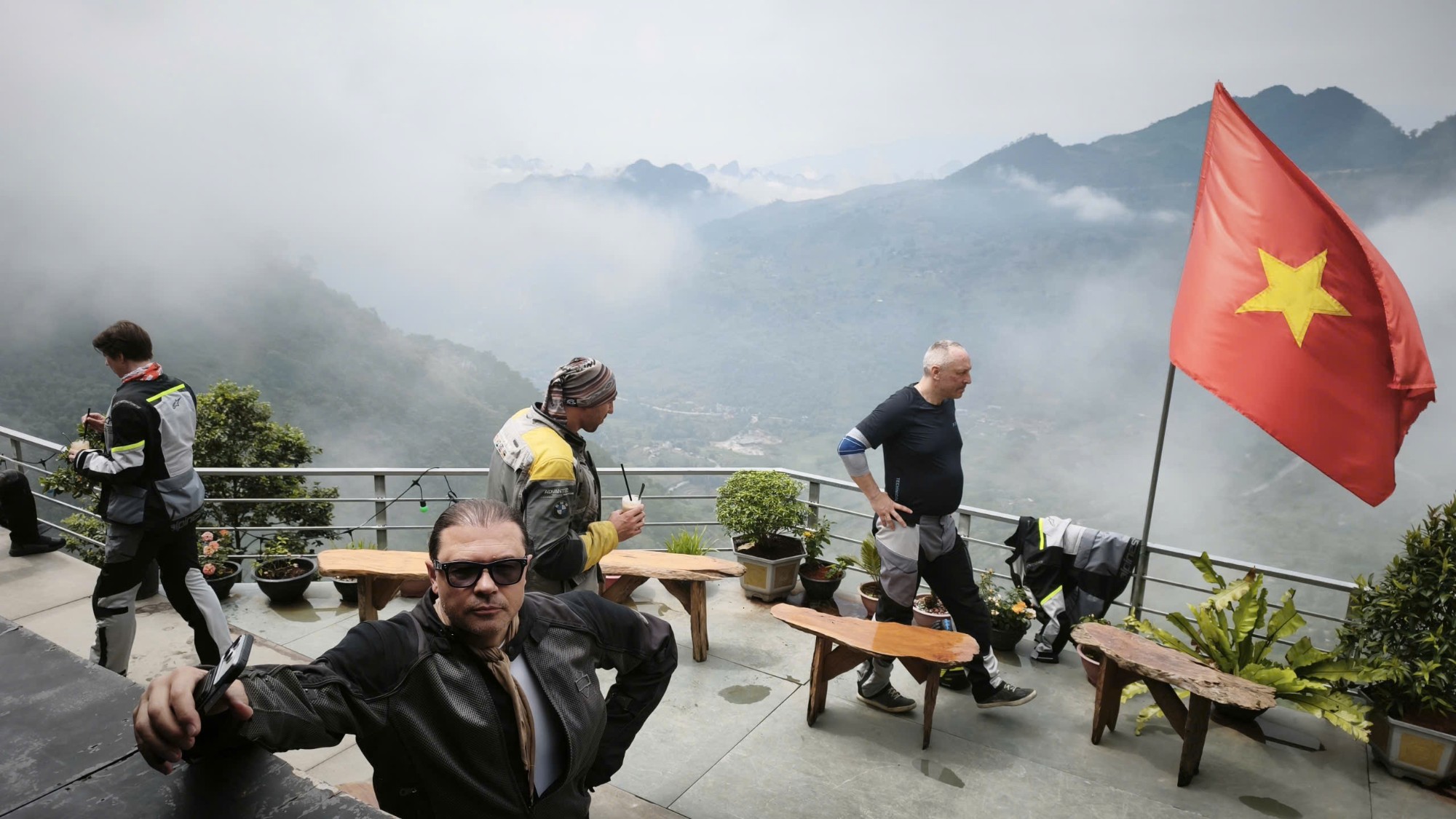 Riders on a mountain terrace above the clouds