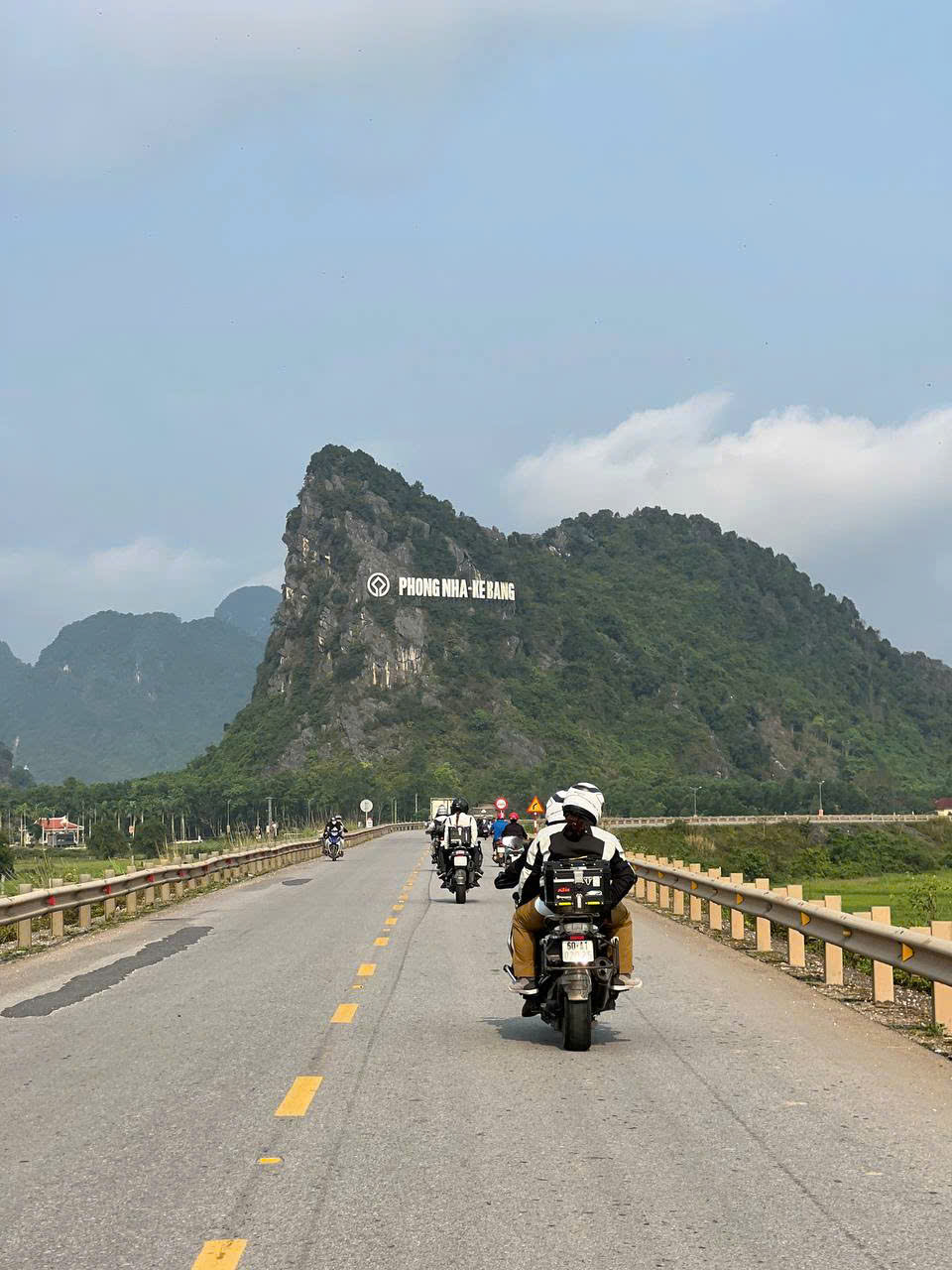Riders heading towards the Phong Nha-Ke Bang mountain sign